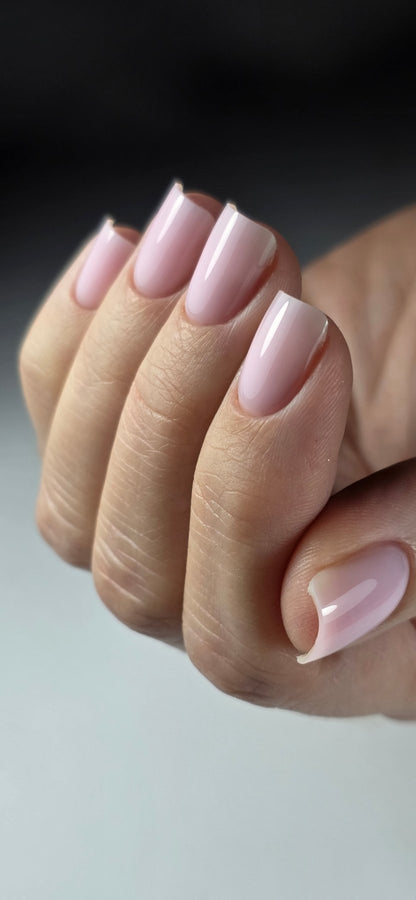 Main fermée aux ongles carrés gainés au gel Easy gel Cutie, rose pâle sur fond gris