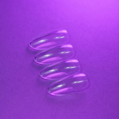 Capsules américaines amande médium natural transparentes posées à plat, second angle