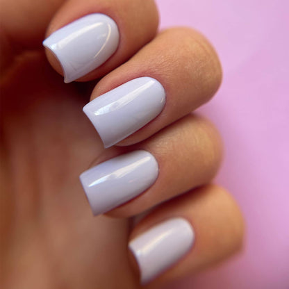 Pose du Gel Polish Besties lilas pâle sur ongles carrés courts, fond rose